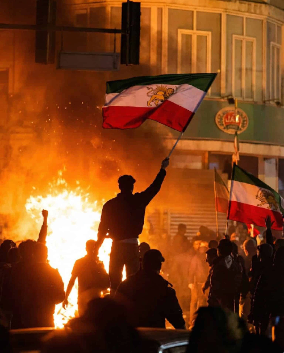 Iranian protestors wave the pre-1979 Iranian flag bearing the lion and sun.
